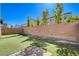 The backyard features artificial turf, brick walls, and stone pavers at 183 Baru Belin Ave, Las Vegas, NV 89183