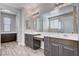 Spacious bathroom with wood-look floors, dual vanities, large mirrors, and a separate shower and tub at 183 Baru Belin Ave, Las Vegas, NV 89183