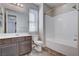 Bright bathroom features a large mirror, white subway tile shower, and wood-look flooring at 183 Baru Belin Ave, Las Vegas, NV 89183