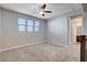 Neutral bedroom filled with natural light features ceiling fan and access to the bathroom at 183 Baru Belin Ave, Las Vegas, NV 89183