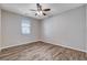 Cozy bedroom featuring wood-look floors, a ceiling fan, and ample natural light at 183 Baru Belin Ave, Las Vegas, NV 89183