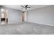 Carpeted bedroom with ceiling fan, adjoining room, and neutral walls at 183 Baru Belin Ave, Las Vegas, NV 89183