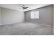 Spacious carpeted bedroom with neutral walls, a ceiling fan with lights, and a window with blinds at 183 Baru Belin Ave, Las Vegas, NV 89183