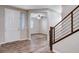 Bright foyer with wood-look floors, staircase with metal railing, and view into the living area at 183 Baru Belin Ave, Las Vegas, NV 89183