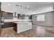 Bright kitchen with a center island, stainless steel appliances, and dark wood cabinets at 183 Baru Belin Ave, Las Vegas, NV 89183