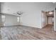 Spacious living room with wood-look floors and a view into the foyer and dining area at 183 Baru Belin Ave, Las Vegas, NV 89183