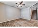 Living room featuring wood-look flooring, ceiling fan, and staircase view at 183 Baru Belin Ave, Las Vegas, NV 89183