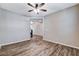 Comfortable living room with wood-look floors, a ceiling fan, and ample space for furniture at 183 Baru Belin Ave, Las Vegas, NV 89183