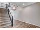 Modern staircase with carpeted steps, metal railings, and decorative lighting at 183 Baru Belin Ave, Las Vegas, NV 89183