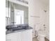 Bathroom featuring a vanity with grey countertop, a framed mirror, and a toilet and shower/tub combo at 211 N Lamb Blvd # C, Las Vegas, NV 89110