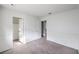 A room with neutral carpet and white walls, featuring a door and a closet entrance, offering space and functionality at 211 N Lamb Blvd # C, Las Vegas, NV 89110