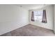 Bright bedroom with neutral walls and carpeting, featuring a window with curtains for soft natural light at 211 N Lamb Blvd # C, Las Vegas, NV 89110