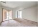 Bedroom featuring neutral carpet, slider door to outdoor balcony, and neutral paint at 211 N Lamb Blvd # C, Las Vegas, NV 89110