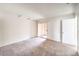 Bedroom featuring neutral carpet, slider door to outdoor balcony, and neutral paint at 211 N Lamb Blvd # C, Las Vegas, NV 89110