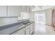 Kitchen featuring stainless steel sink, dishwasher, gray countertops, and a sliding glass door to outside at 211 N Lamb Blvd # C, Las Vegas, NV 89110