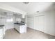 An open kitchen area features white cabinetry, gray countertops, and is situated adjacent to a dining area at 211 N Lamb Blvd # C, Las Vegas, NV 89110