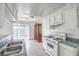 Kitchen featuring stainless steel sink, range, gray countertops, and a sliding glass door to outside at 211 N Lamb Blvd # C, Las Vegas, NV 89110