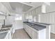 A well-lit kitchen features white cabinetry, gray countertops, and includes modern appliances at 211 N Lamb Blvd # C, Las Vegas, NV 89110