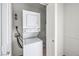 Compact laundry area featuring a stacked washer and dryer unit, optimizing space and convenience at 211 N Lamb Blvd # C, Las Vegas, NV 89110