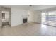 Bright living room with tile floors, neutral walls and a cozy fireplace with an adjourning dining area at 211 N Lamb Blvd # C, Las Vegas, NV 89110