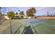 Community tennis court offers a recreational space surrounded by mature trees and landscaping at 211 N Lamb Blvd # C, Las Vegas, NV 89110