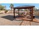 Backyard featuring a charming gazebo with dining set, offering an ideal space for outdoor entertaining and relaxation at 2111 River City Dr, Laughlin, NV 89029