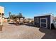 Well-maintained backyard with a pergola, shed, and desert landscaping at 2111 River City Dr, Laughlin, NV 89029