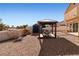 Spacious backyard featuring a pergola, shed, and desert landscaping at 2111 River City Dr, Laughlin, NV 89029