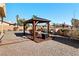 Landscaped backyard featuring a cozy gazebo with seating, perfect for outdoor relaxation and entertainment at 2111 River City Dr, Laughlin, NV 89029