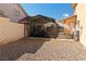 Gravel backyard with a covered carport, providing parking and protection for vehicles and equipment at 2111 River City Dr, Laughlin, NV 89029