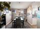 Charming dining area with a gray wooden table, rug, and a travel themed decor at 2111 River City Dr, Laughlin, NV 89029