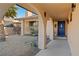 Exterior entryway with archways leading to a blue front door and desert landscaping at 2111 River City Dr, Laughlin, NV 89029