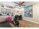 Bright exercise room featuring a ceiling fan, wood floors, and Gathering portrait decor at 2111 River City Dr, Laughlin, NV 89029