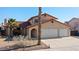 Charming stucco home with an attached three-car garage and desert landscaping at 2111 River City Dr, Laughlin, NV 89029