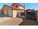 Home's exterior with a two-car garage, gated entrance, and a convenient carport for additional parking at 2111 River City Dr, Laughlin, NV 89029