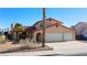 Charming two-story home features a terracotta roof, a spacious three-car garage, and desert landscaping at 2111 River City Dr, Laughlin, NV 89029