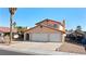 Charming two-story home features a terracotta roof, a spacious three-car garage, and desert landscaping at 2111 River City Dr, Laughlin, NV 89029