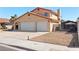 Exterior view showing the three-car garage, driveway, and gated side yard at 2111 River City Dr, Laughlin, NV 89029