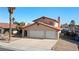 Charming two-story home features a terracotta roof, a spacious three-car garage, and desert landscaping at 2111 River City Dr, Laughlin, NV 89029