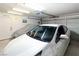 Clean garage with car, covering, and 'Personal Cave' entrance door at 2111 River City Dr, Laughlin, NV 89029