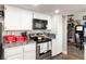 Modern kitchen featuring white cabinets, stainless steel appliances, and a cozy dining area at 2111 River City Dr, Laughlin, NV 89029