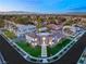 Expansive aerial view of a meticulously landscaped home with a distant city skyline at 2293 Buckingham Ct, Henderson, NV 89074