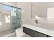 Contemporary bathroom showcasing a glass shower, dual shower heads, and modern vanity at 2293 Buckingham Ct, Henderson, NV 89074