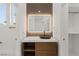 Modern bathroom with a vessel sink, illuminated mirror, and stylish wood vanity at 2293 Buckingham Ct, Henderson, NV 89074