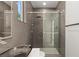 Sleek bathroom with a glass-enclosed shower and dark tiled walls at 2293 Buckingham Ct, Henderson, NV 89074