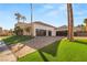 Beautifully landscaped home featuring an expansive driveway and a well-manicured lawn at 2293 Buckingham Ct, Henderson, NV 89074