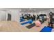 Bright home gym features mirrored walls, light wood floors, and an array of fitness equipment at 2293 Buckingham Ct, Henderson, NV 89074