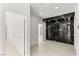 Hallway with modern marble accent wall, white doors and recessed lighting at 2293 Buckingham Ct, Henderson, NV 89074