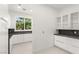 Modern kitchenette with white cabinets, dark countertops, and ample storage space at 2293 Buckingham Ct, Henderson, NV 89074