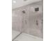 Modern, spacious shower stall with dual shower heads and marble tile surround at 2293 Buckingham Ct, Henderson, NV 89074